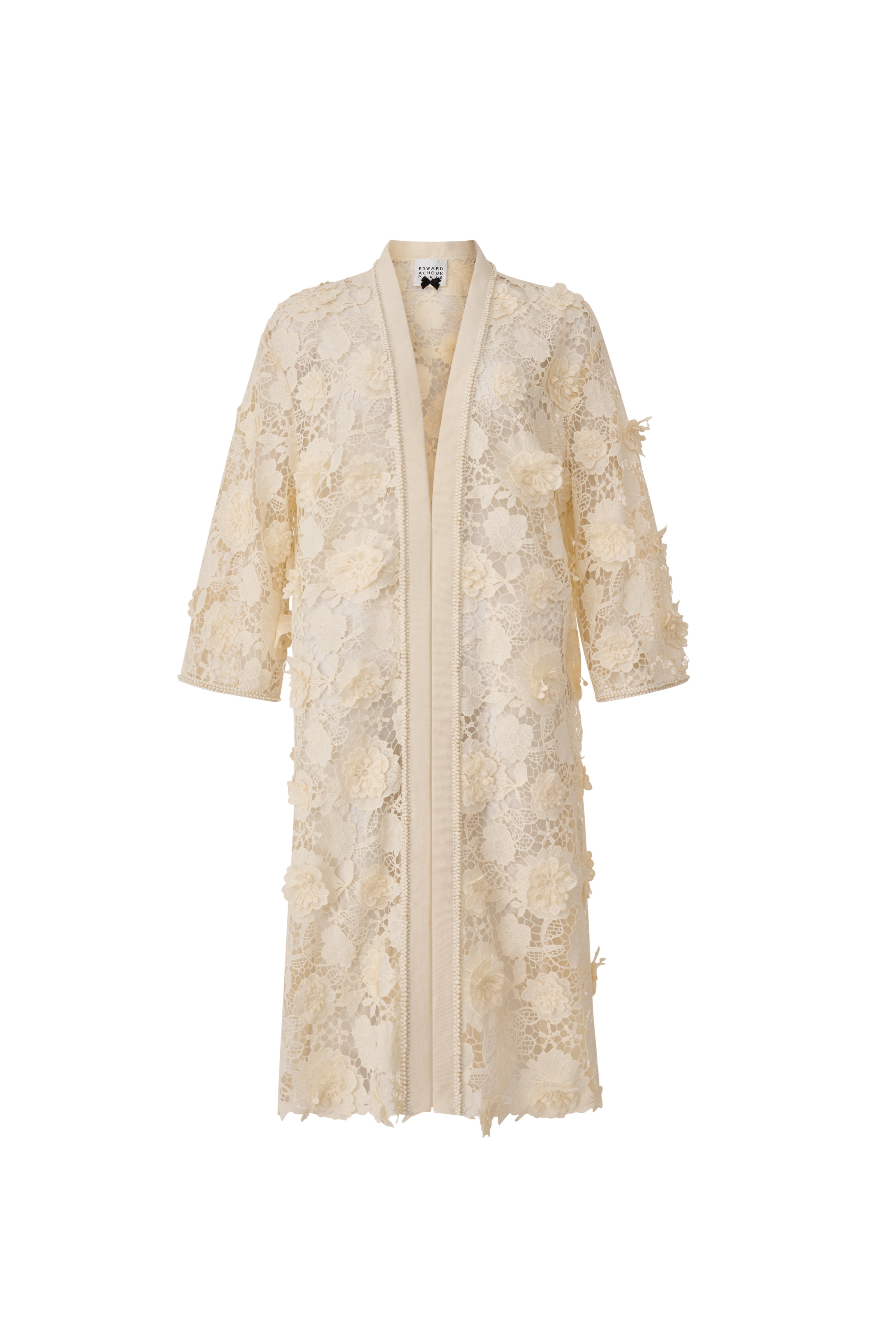 Front view of a long ivory lace coat featuring 3D floral embellishments and an oversized A-line silhouette by Edward Achour.