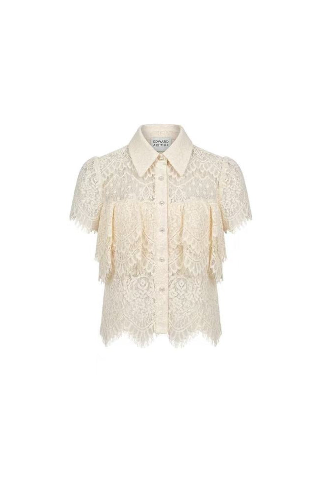 Front view of a cream Edward Achour short-sleeved lace shirt with tiered ruffles and pearl buttons.