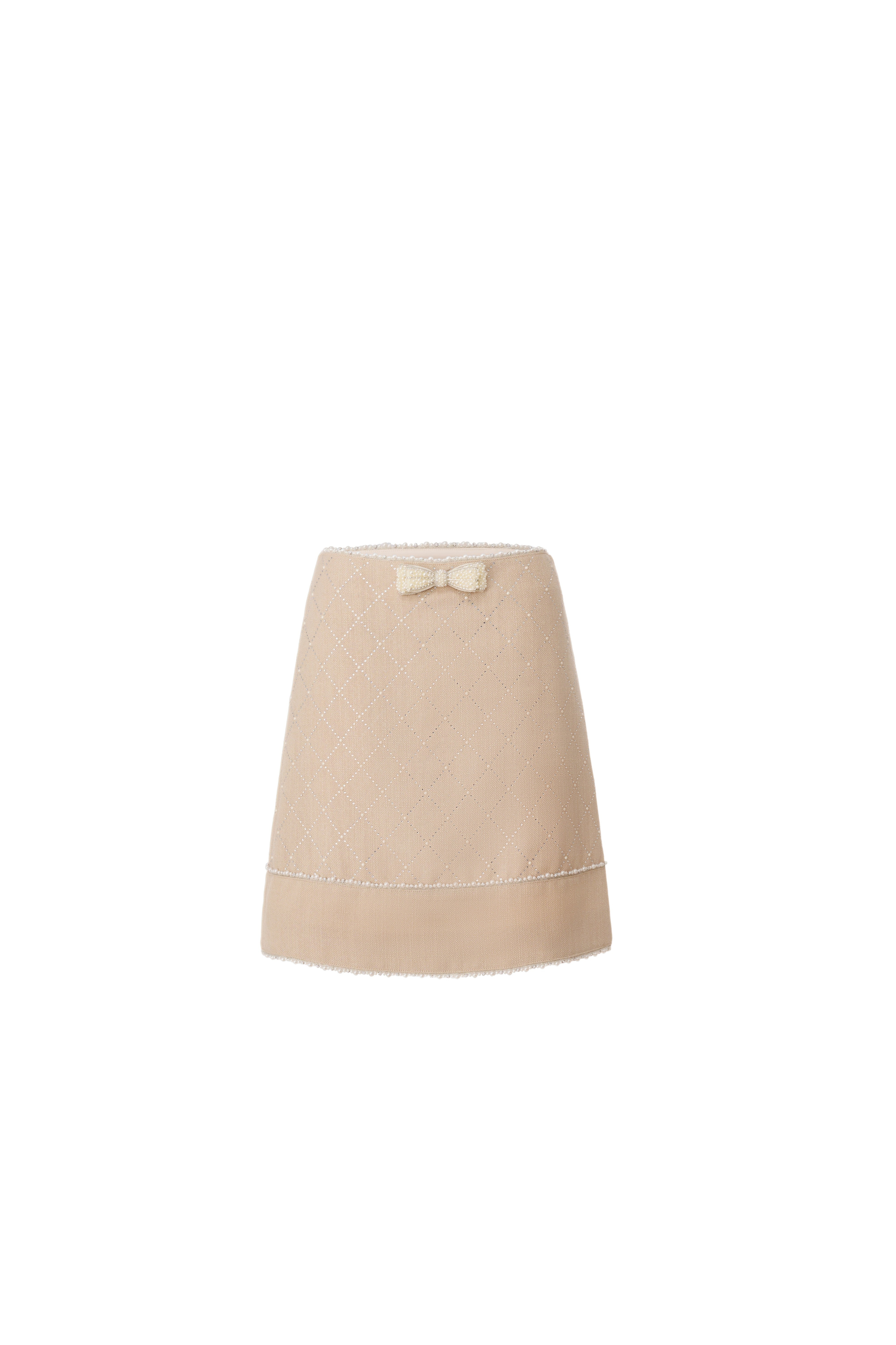 Front view of a beige A-line mini skirt with a tiny pearl bow and beaded borders.