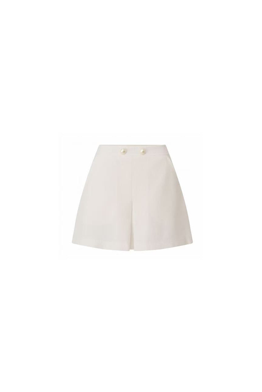 Front view of Edward Achour white high-waisted mini skirt with pearl buttons.