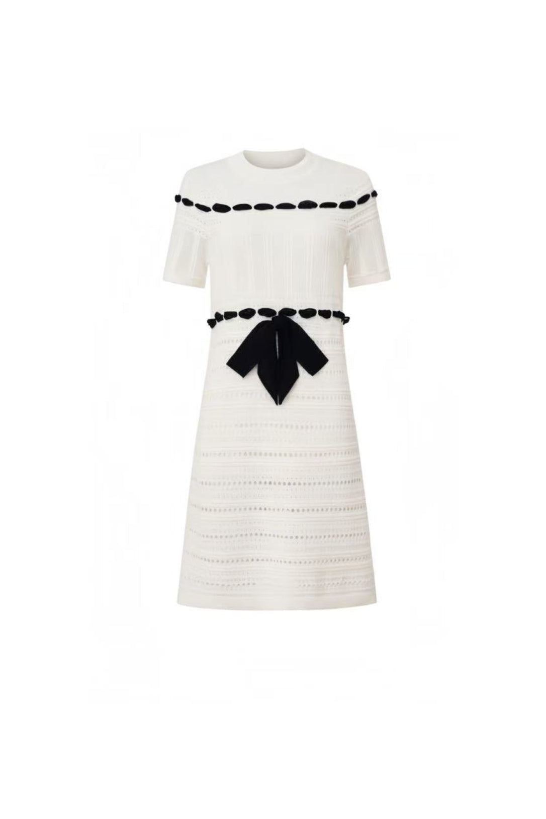 Front view of Edward Achour white short-sleeve knit dress with black bow and trim.