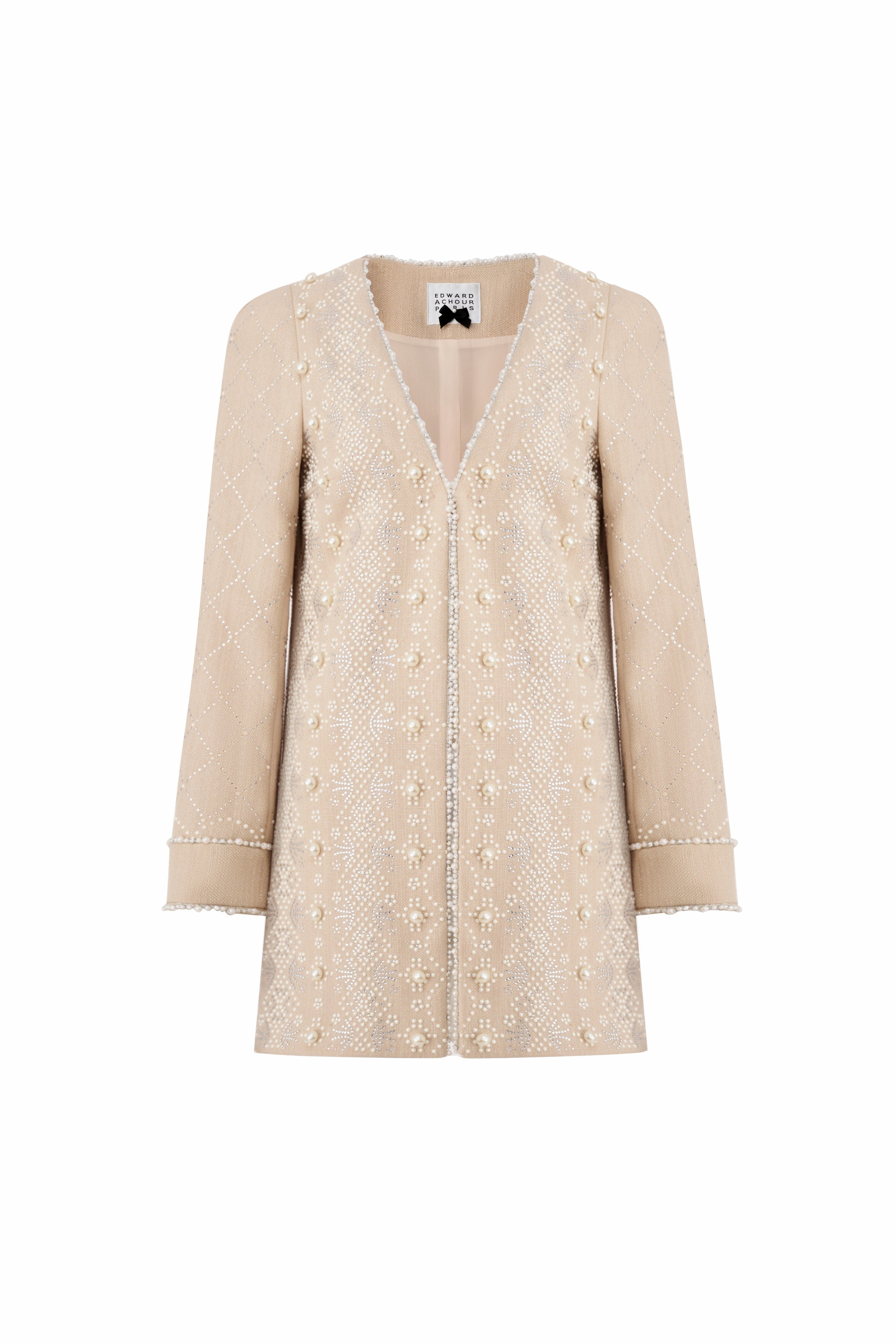 Front view of a luxury beige long-line jacket with all-over diamond-patterned pearl embellishments and pearl-beaded trim by Edward Achour.