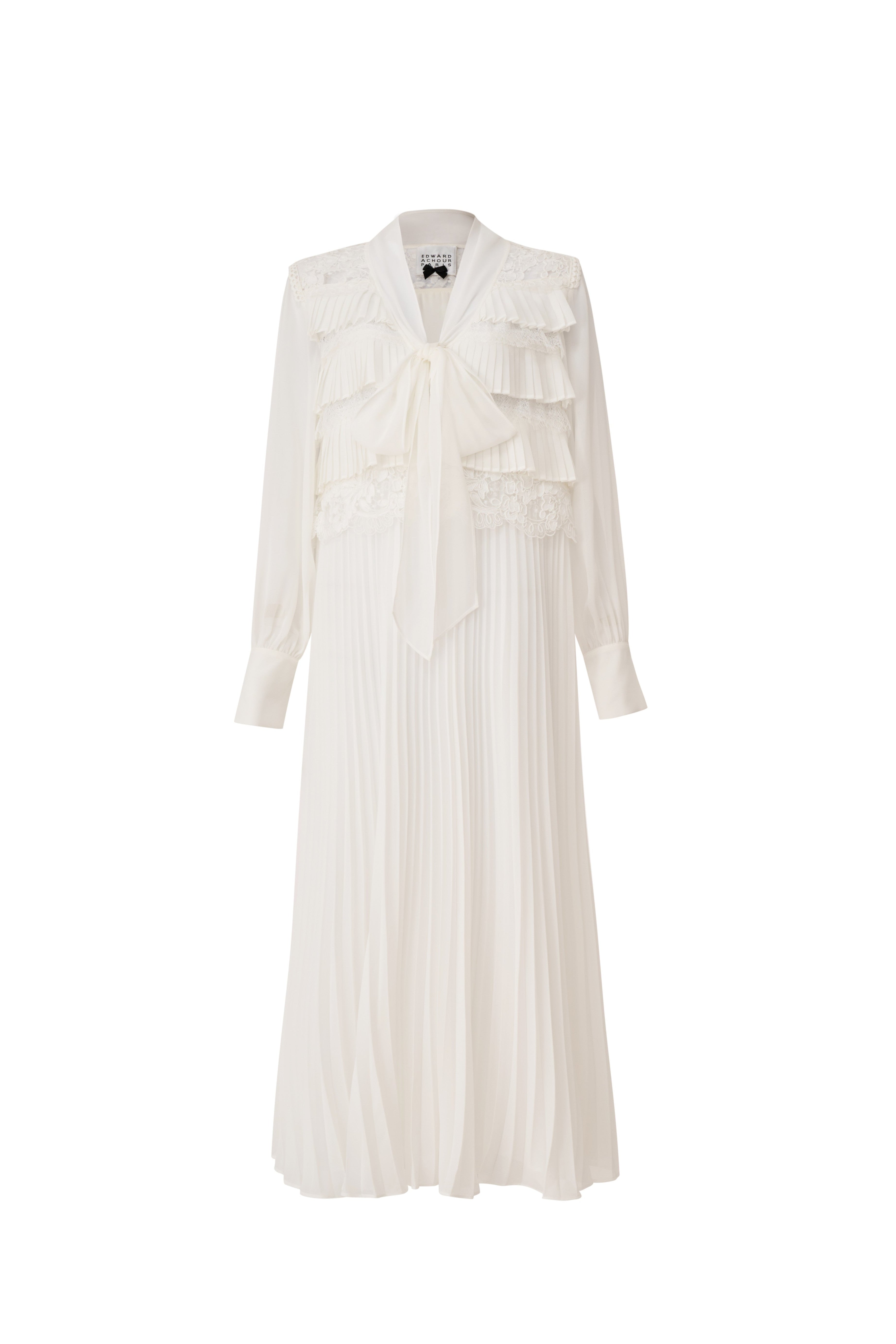 Front view of a white pleated midi dress with a pussy-bow tie and lace accents by Edward Achour.