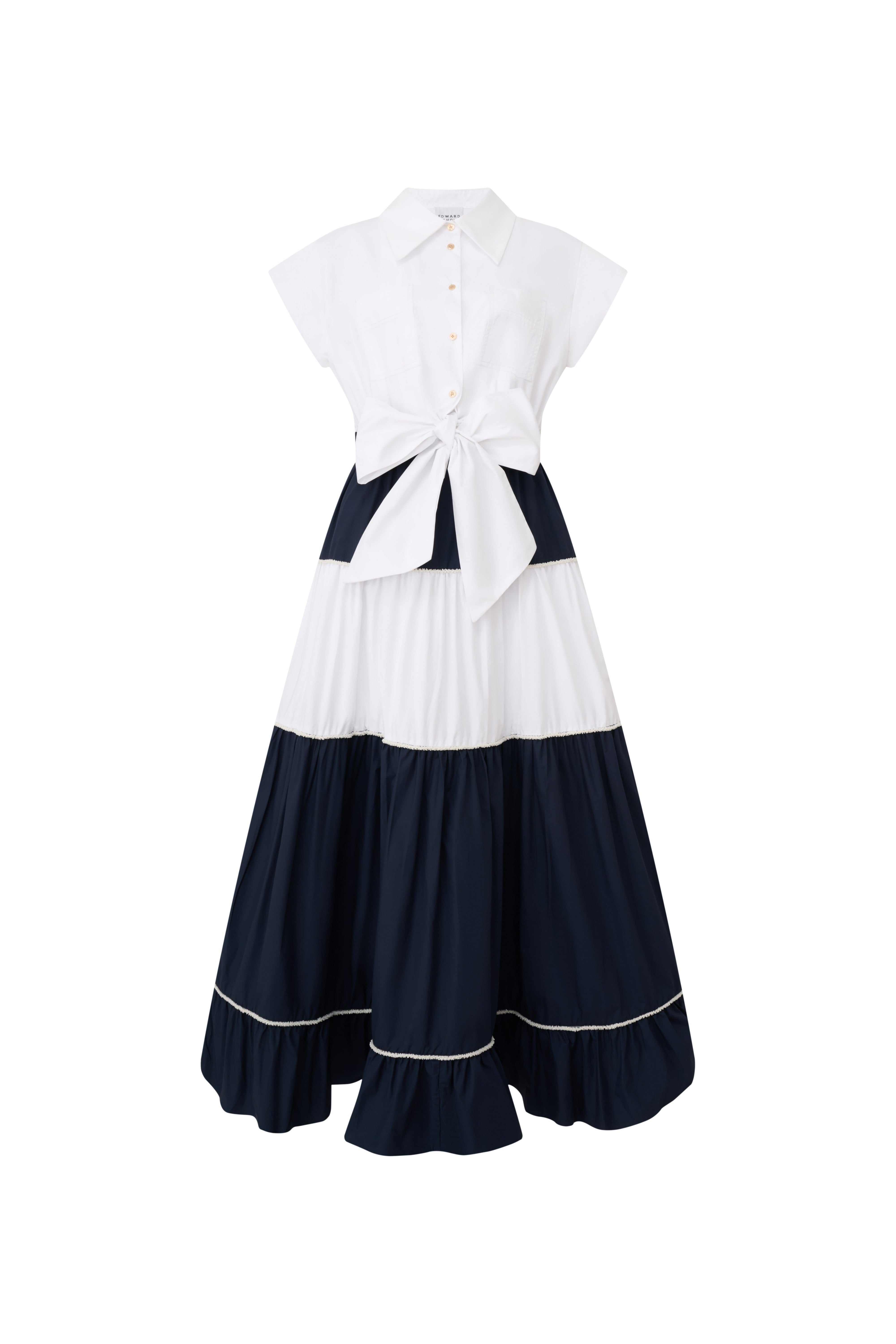 Front view of a navy and white color-block tiered midi dress with a large waist bow by Edward Achour.